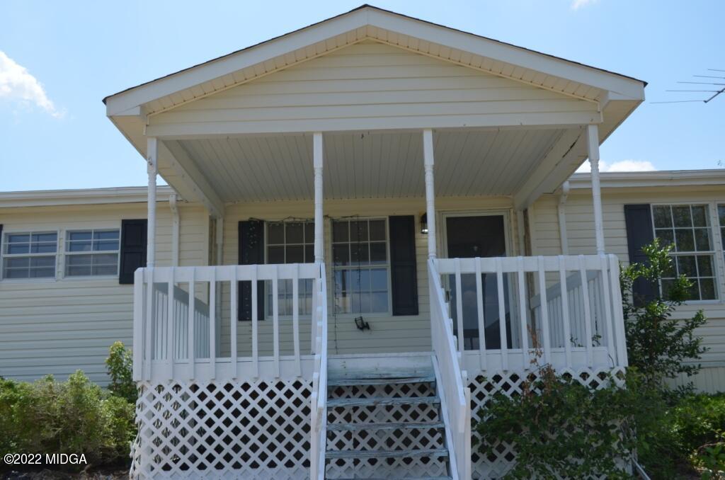 171 Dillon Road Butler, GA 31006 - Photo 3 of 22 a front view of a house with a porch
