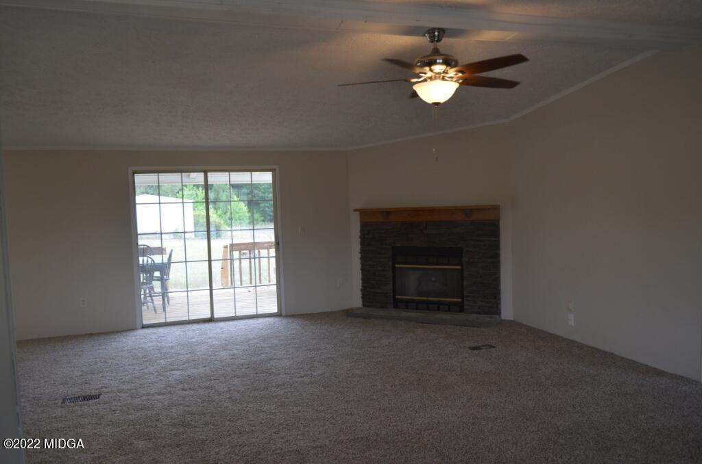171 Dillon Road Butler, GA 31006 - Photo 6 of 22 an empty room with windows and ceiling fan