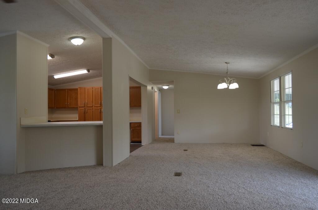 171 Dillon Road Butler, GA 31006 - Photo 8 of 22 an empty room with windows and entrance