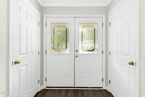 a view of an entryway with wooden floor