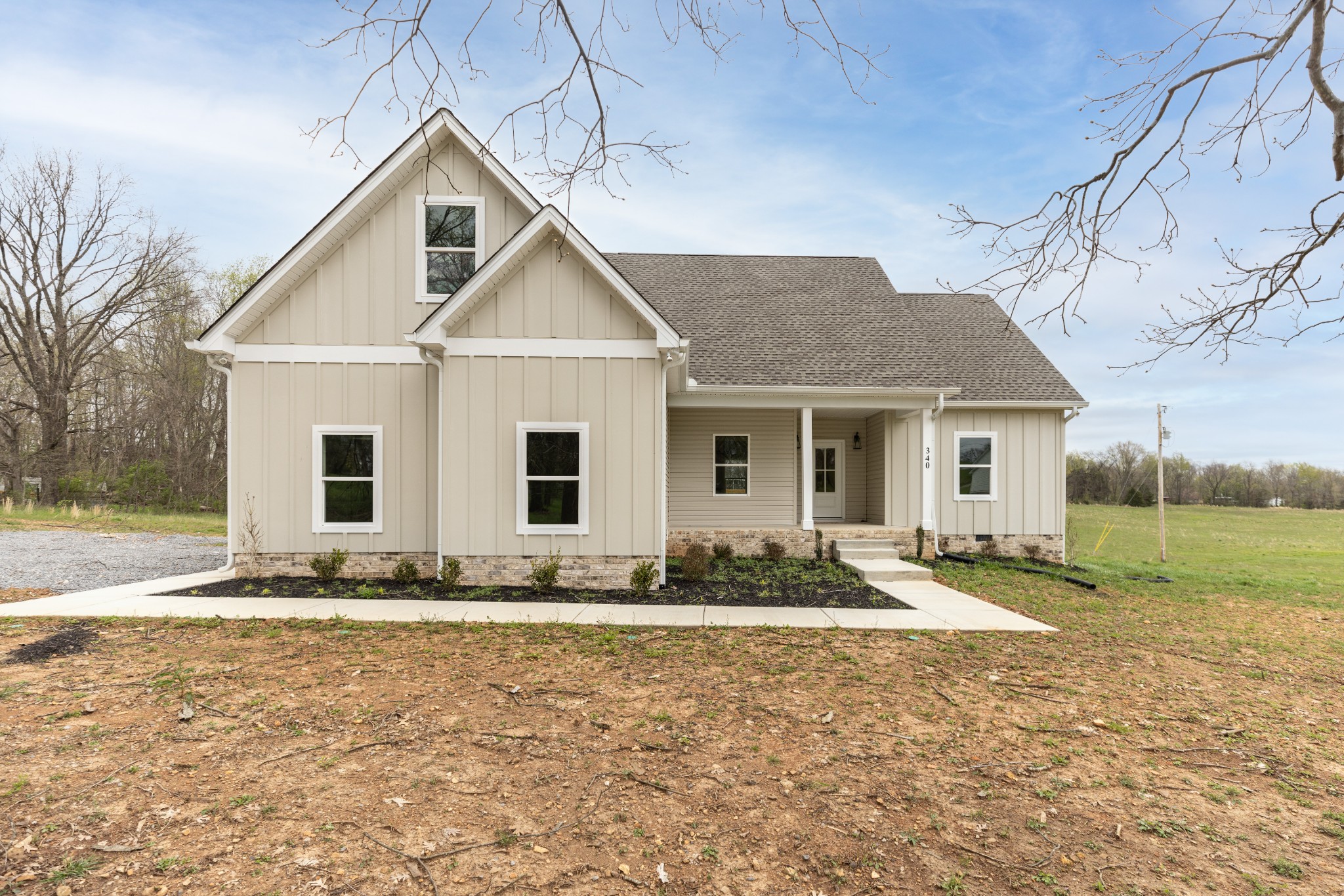 340 Woodruff Road Adams, TN 37010 - Photo 1 of 15 a front view of a house with garden