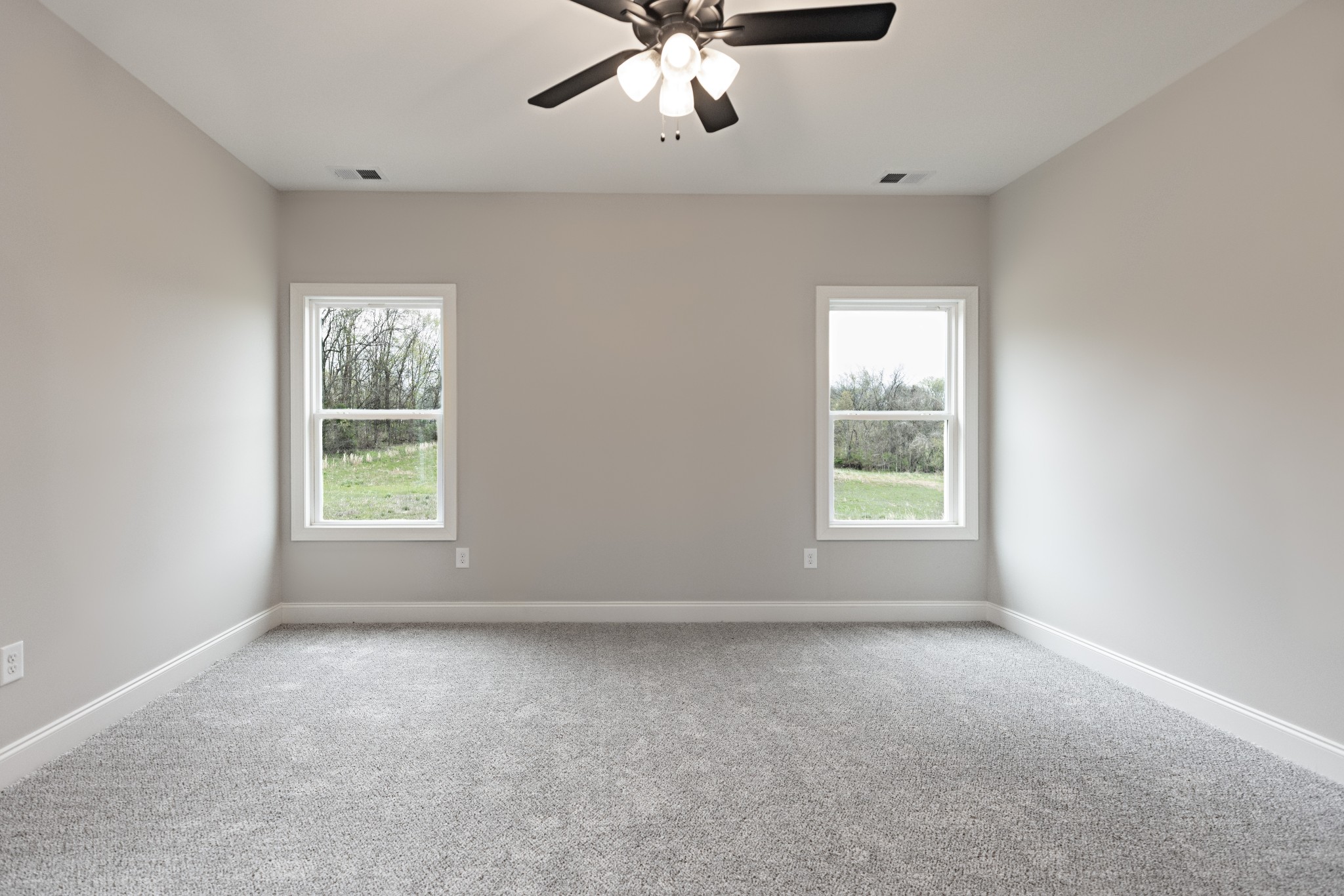 340 Woodruff Road Adams, TN 37010 - Photo 8 of 15 an empty room with windows and chandelier fan