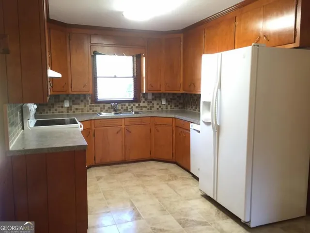 a kitchen with stainless steel appliances a refrigerator and a sink