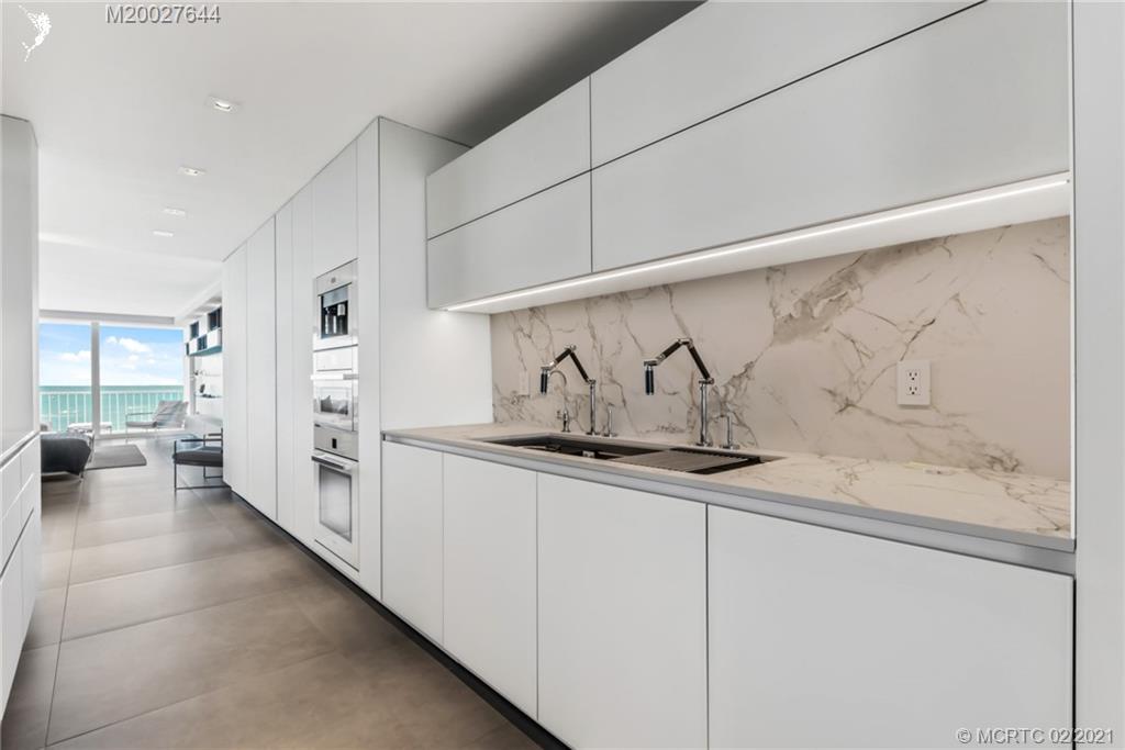 2001 Southeast Sailfish Point Boulevard, Unit 412 Stuart, FL 34996 - Photo 13 of 54 a kitchen with sink and cabinets