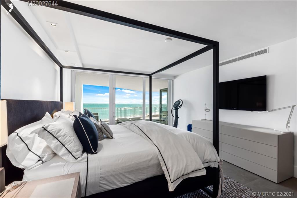 2001 Southeast Sailfish Point Boulevard, Unit 412 Stuart, FL 34996 - Photo 15 of 54 a bedroom with a bed and a flat tv screen