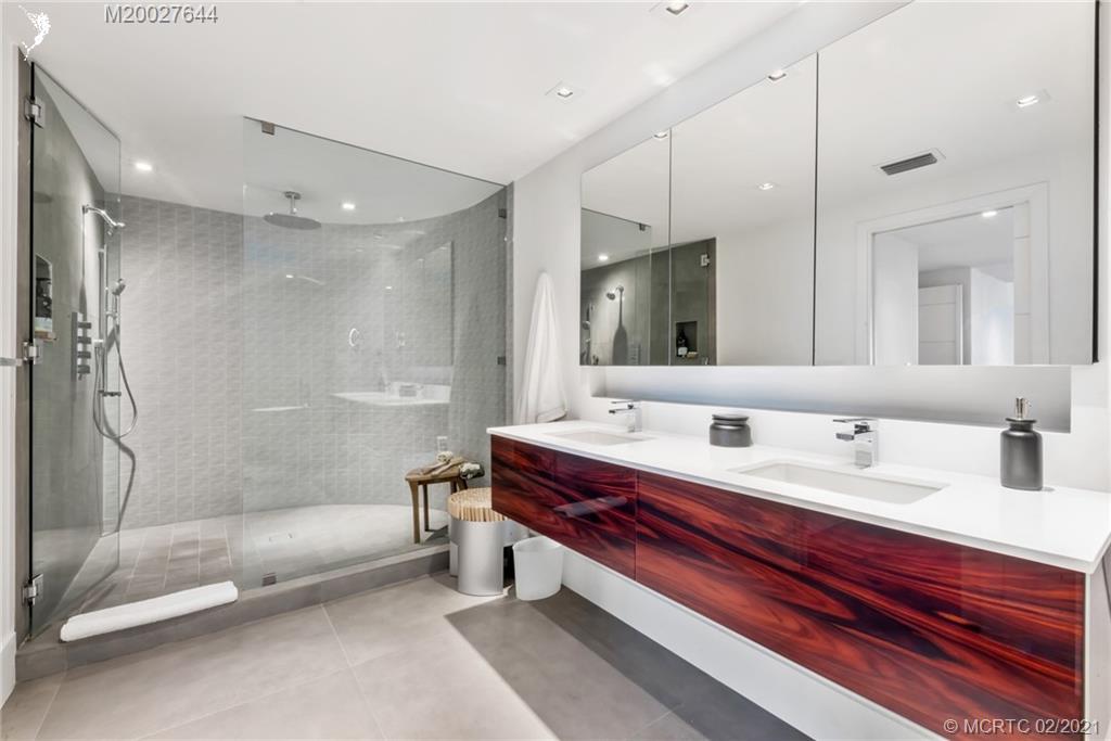 2001 Southeast Sailfish Point Boulevard, Unit 412 Stuart, FL 34996 - Photo 16 of 54 a spacious bathroom with a tub double sink shower and mirror