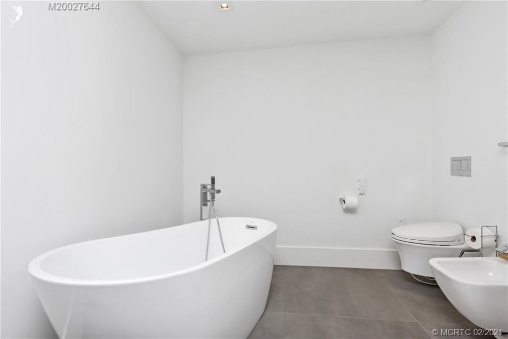 2001 Southeast Sailfish Point Boulevard, Unit 412 Stuart, FL 34996 - Photo 17 of 54 a white bath tub sitting next to a white toilet