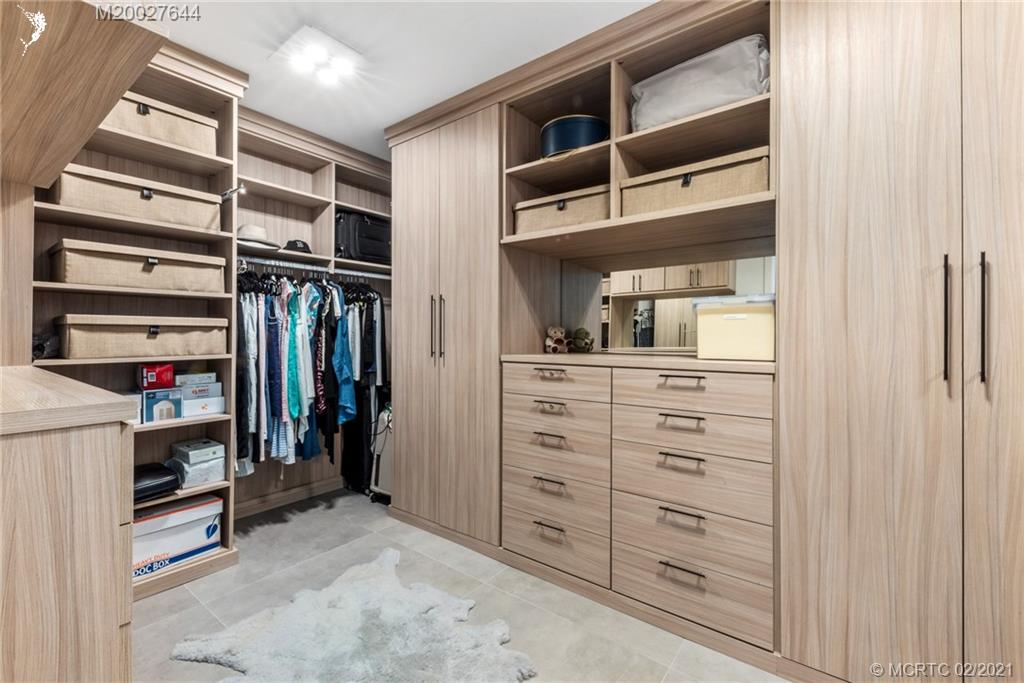 2001 Southeast Sailfish Point Boulevard, Unit 412 Stuart, FL 34996 - Photo 18 of 54 a view of walk in closet with clothes and shoes