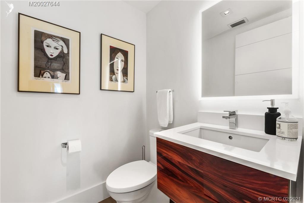 2001 Southeast Sailfish Point Boulevard, Unit 412 Stuart, FL 34996 - Photo 22 of 54 a bathroom with a toilet a sink and mirror