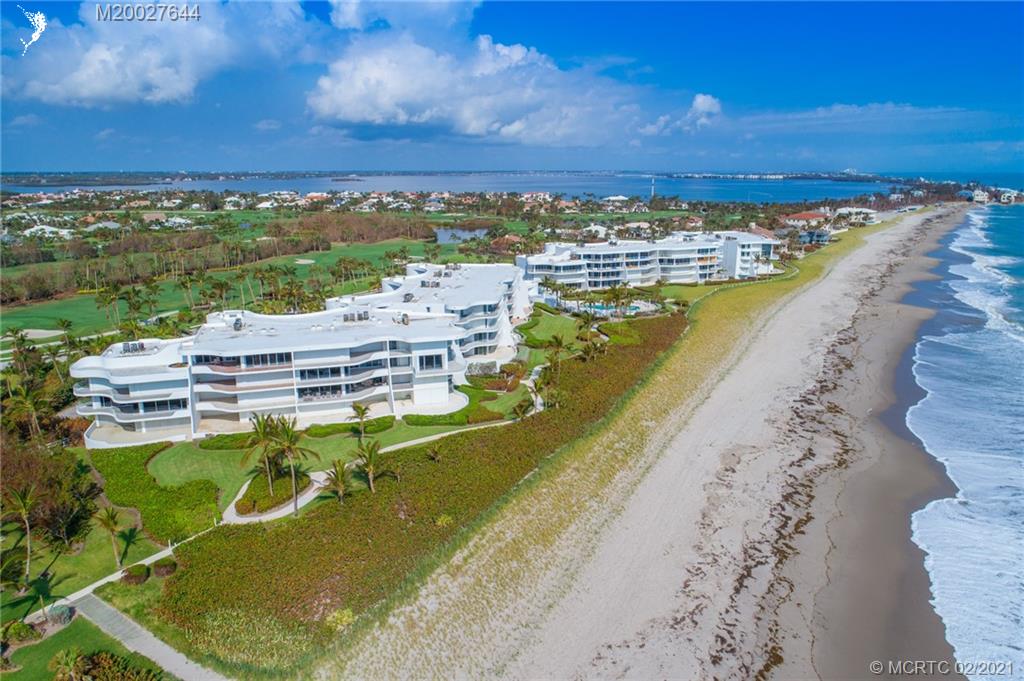 2001 Southeast Sailfish Point Boulevard, Unit 412 Stuart, FL 34996 - Photo 24 of 54 a view of a swimming pool with a table and chairs