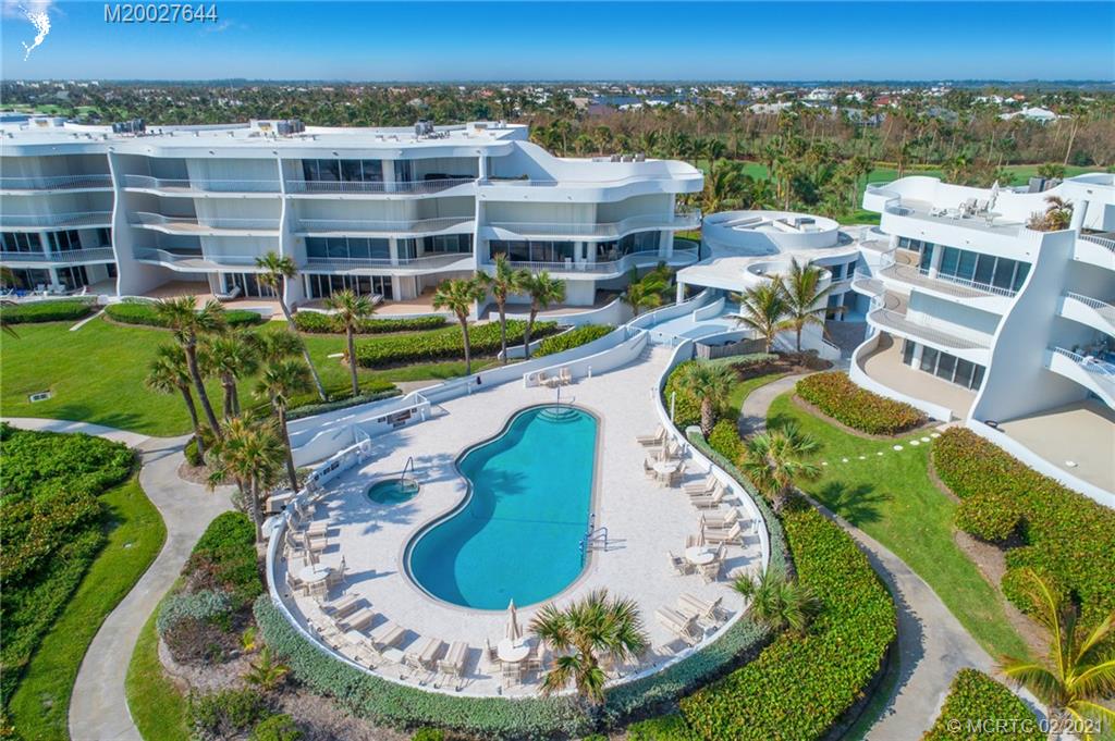 2001 Southeast Sailfish Point Boulevard, Unit 412 Stuart, FL 34996 - Photo 28 of 54 an aerial view of a house with a swimming pool and mountains