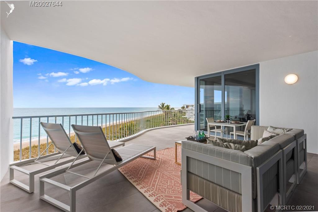 2001 Southeast Sailfish Point Boulevard, Unit 412 Stuart, FL 34996 - Photo 35 of 54 a living room with furniture and floor to ceiling windows