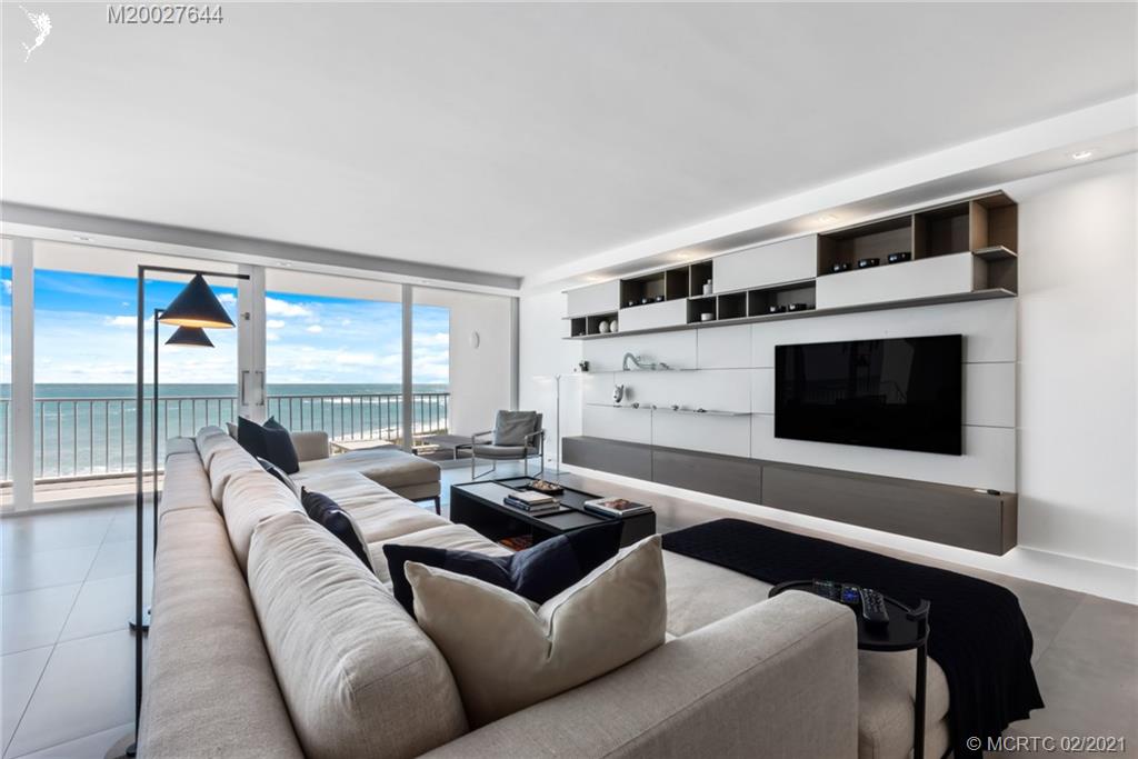 2001 Southeast Sailfish Point Boulevard, Unit 412 Stuart, FL 34996 - Photo 7 of 54 a living room with furniture and a flat screen tv