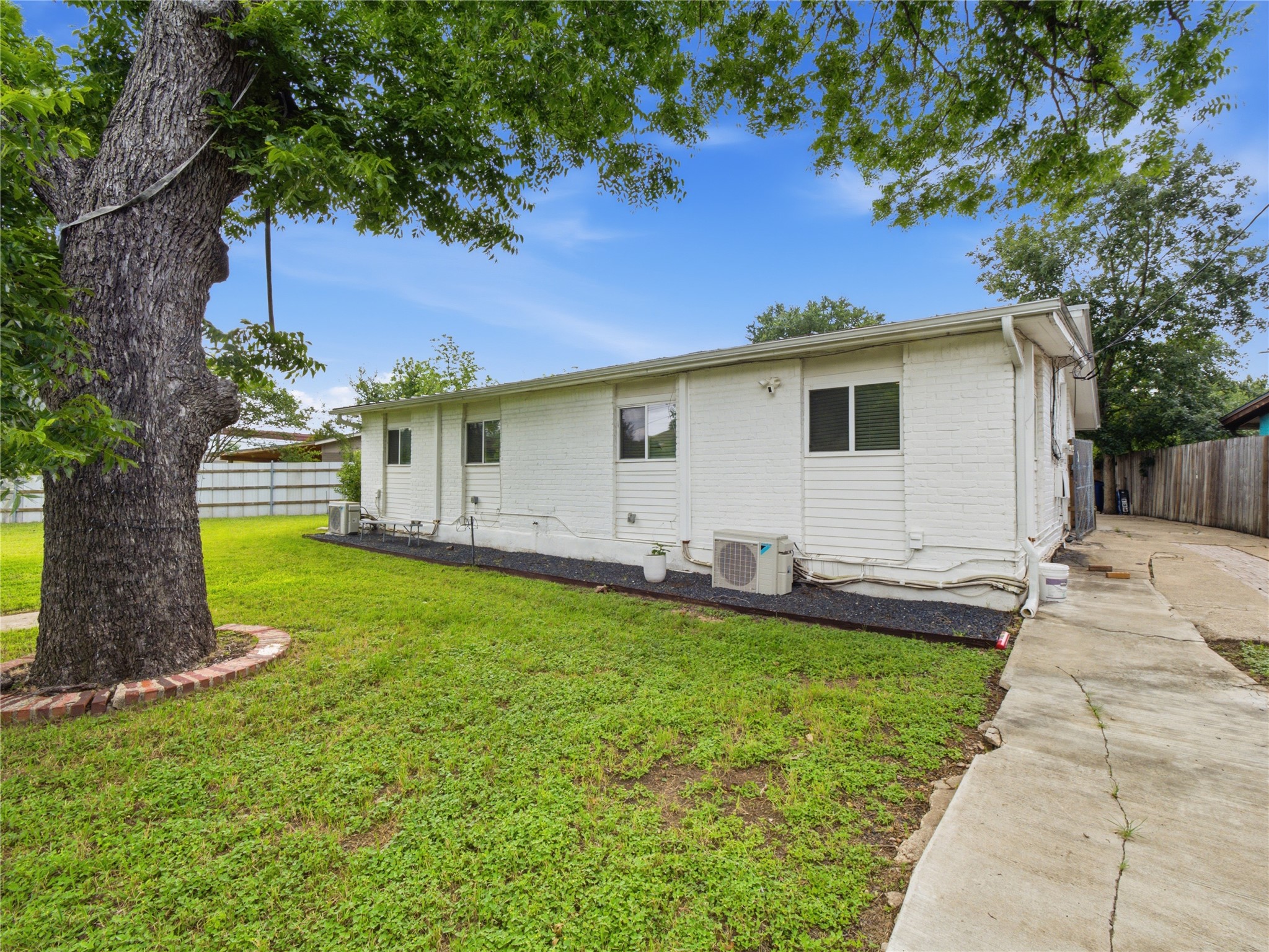 1108 Jolena Circle Austin, TX 78721 - Photo 18 of 21 Mature trees and a well-kept lawn frame this property's simple charm.