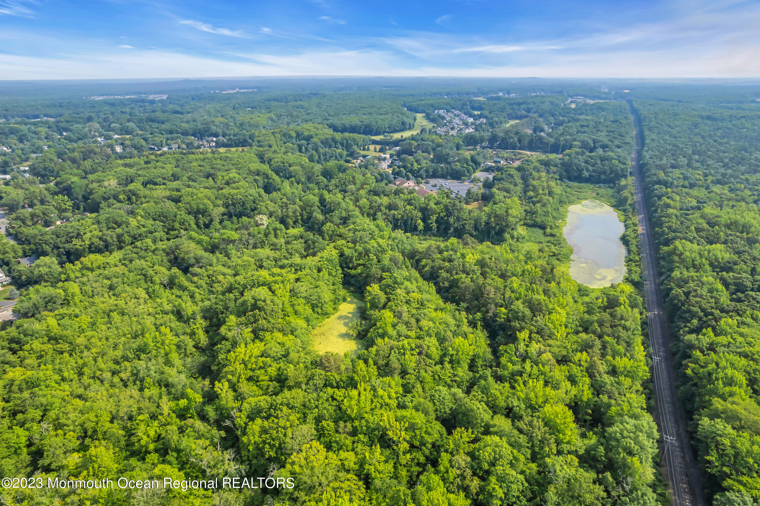 51 Asbury Road Farmingdale, NJ 07727 - Photo 7 of 17 an aerial view of residential houses with outdoor space and trees