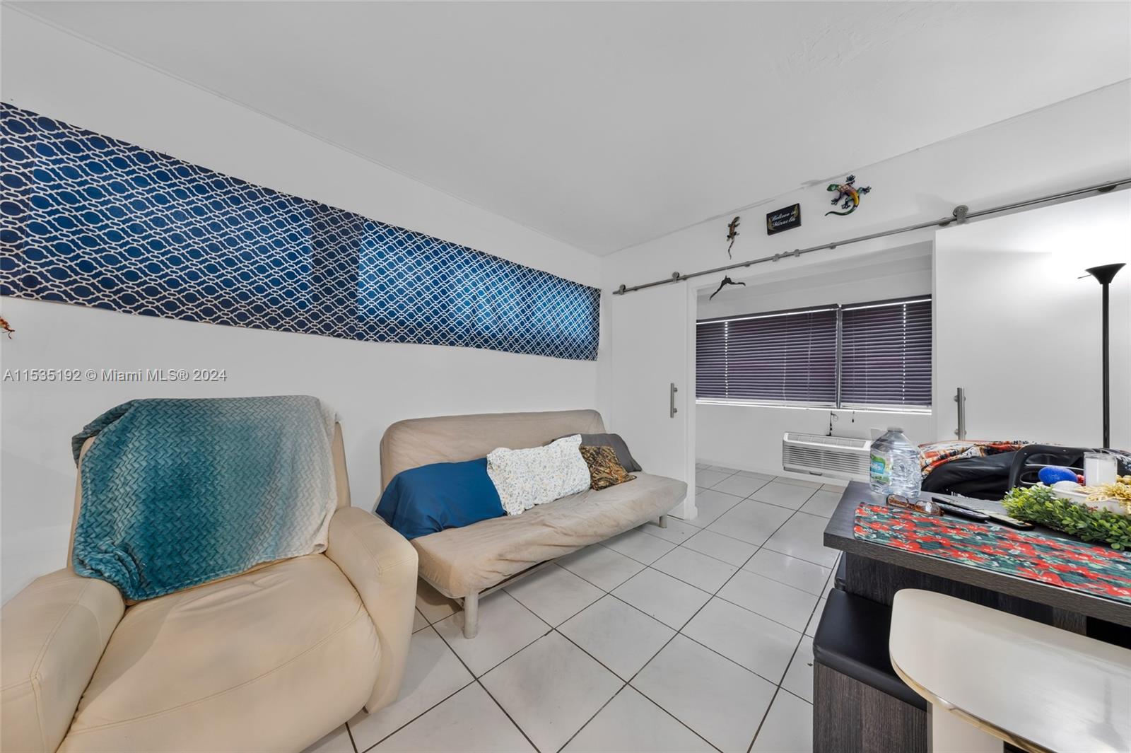 235 78th Street Miami Beach, FL 33141 - Photo 26 of 36 a living room with furniture and a window