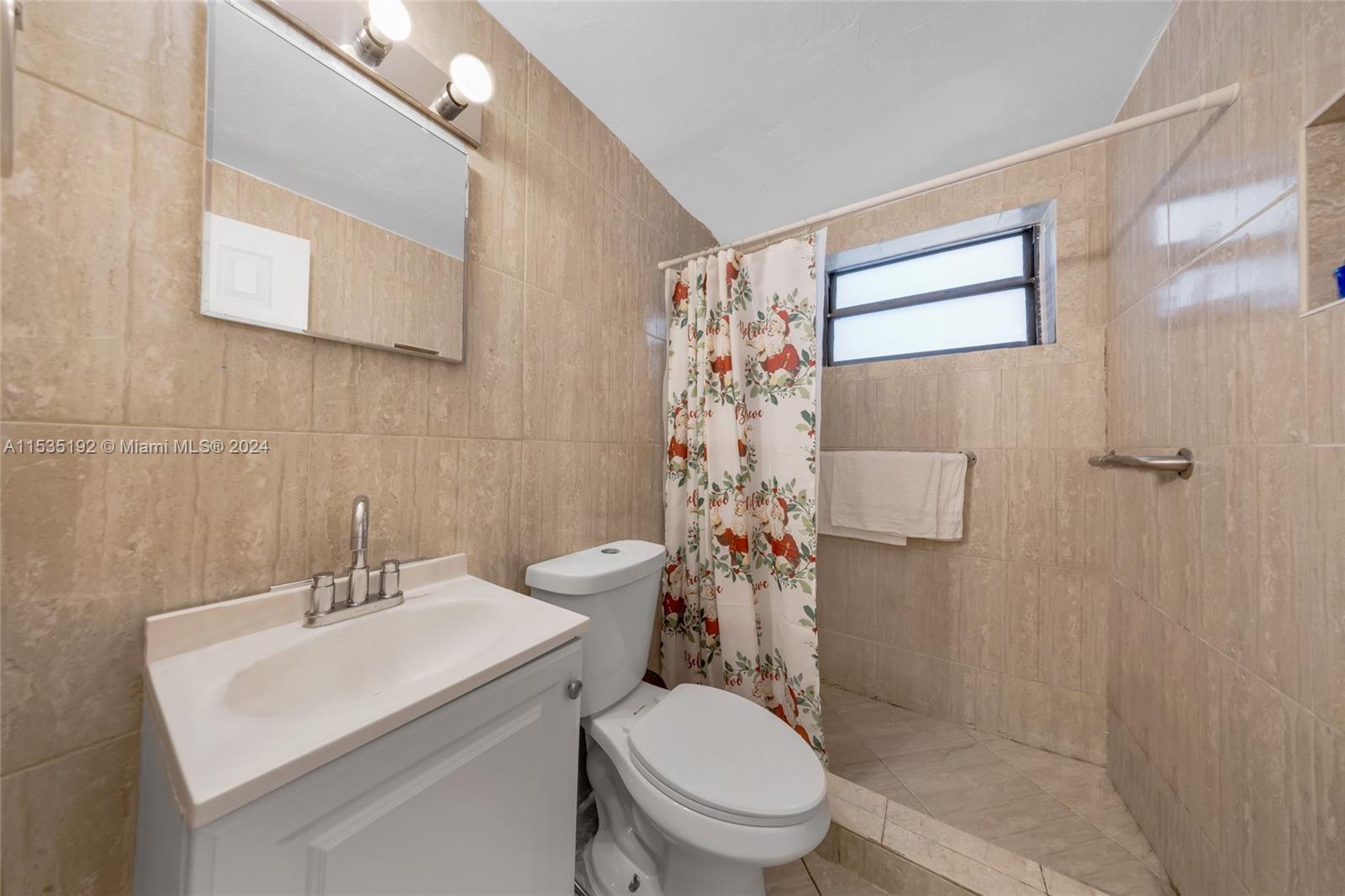 235 78th Street Miami Beach, FL 33141 - Photo 28 of 36 a bathroom with a sink toilet and shower