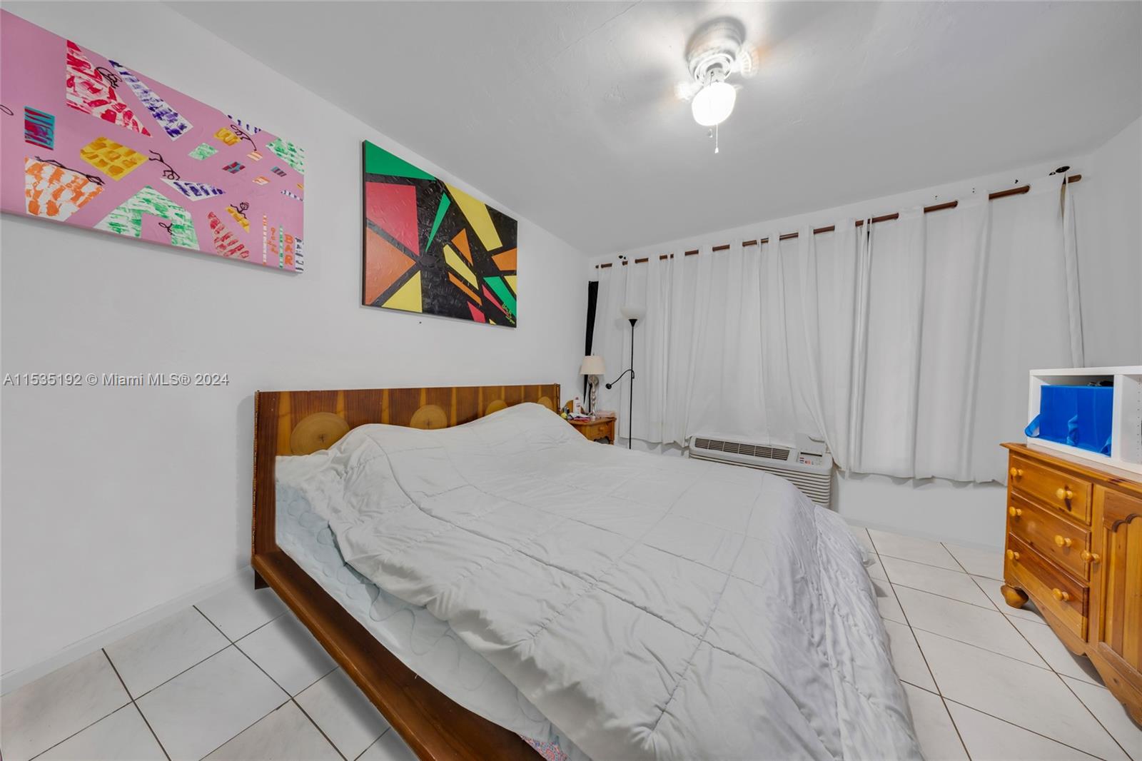 235 78th Street Miami Beach, FL 33141 - Photo 29 of 36 a bedroom with a bed and a painting on the wall