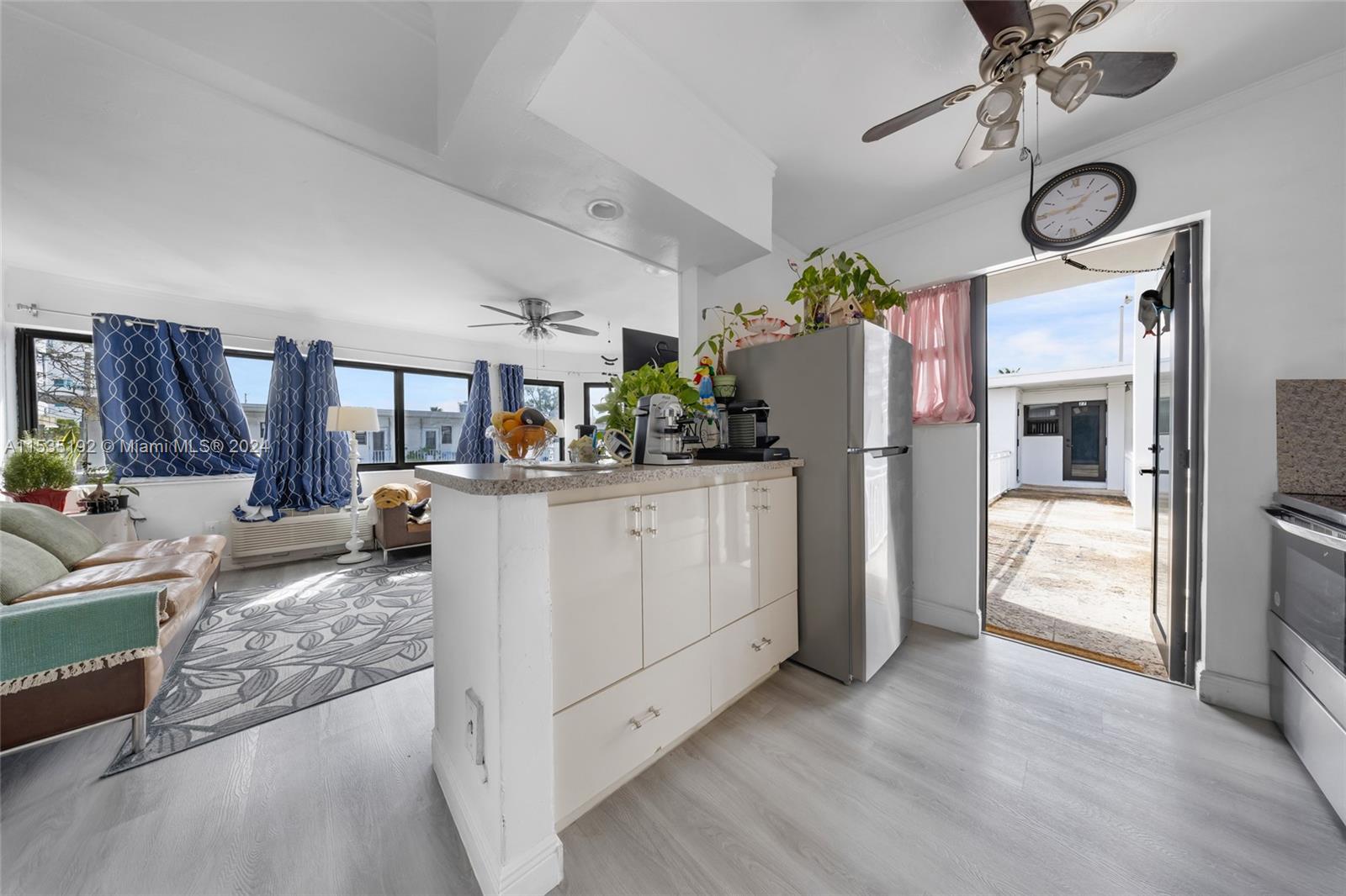 235 78th Street Miami Beach, FL 33141 - Photo 31 of 36 a kitchen with a refrigerator and a stove