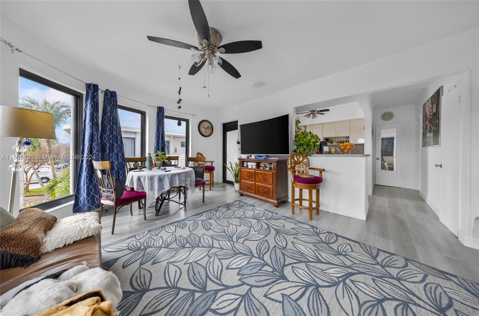 235 78th Street Miami Beach, FL 33141 - Photo 33 of 36 a living room with furniture and a flat screen tv
