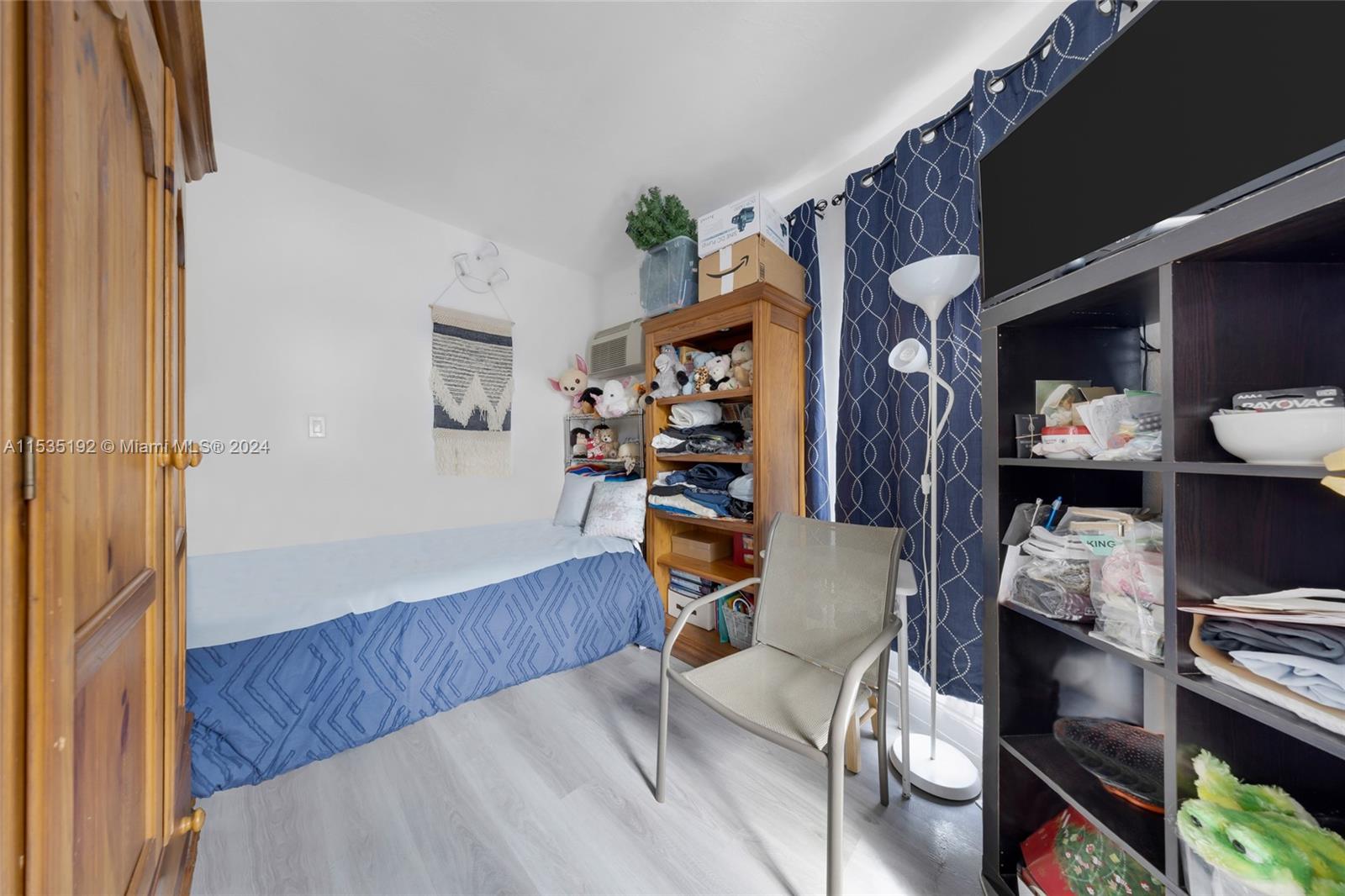 235 78th Street Miami Beach, FL 33141 - Photo 34 of 36 a view of a bedroom with workspace and bedroom