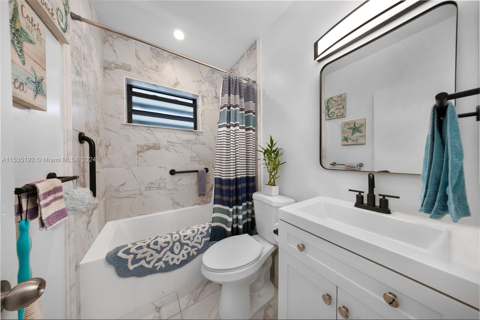 235 78th Street Miami Beach, FL 33141 - Photo 35 of 36 a bathroom with a sink toilet and shower