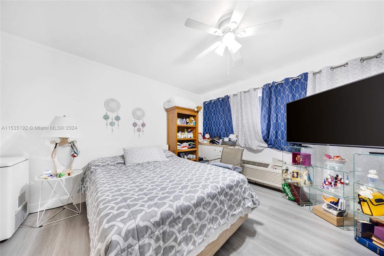 235 78th Street Miami Beach, FL 33141 - Photo 36 of 36 a bedroom with a bed and a flat screen tv