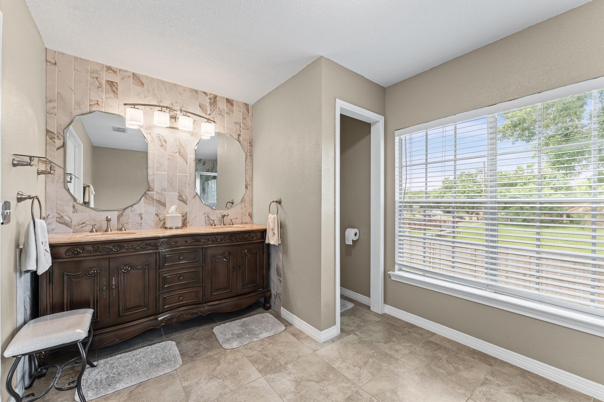 9903 Burntfork Street Houston, TX 77064 - Photo 14 of 25 Recently remodeled primary bathroom equipped with double sinks.