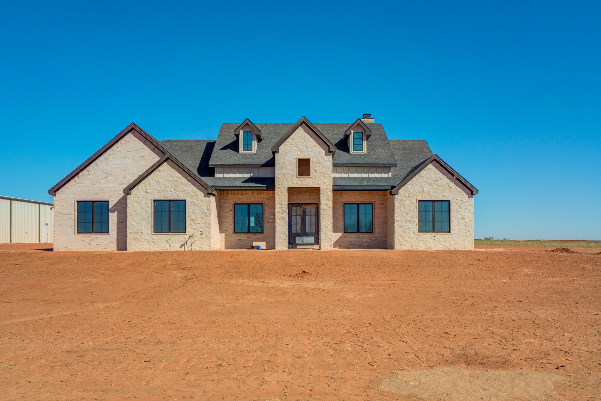 6309 Foster Road Ropesville, TX 79358 - Photo 2 of 38 a front view of a house with a yard and garage