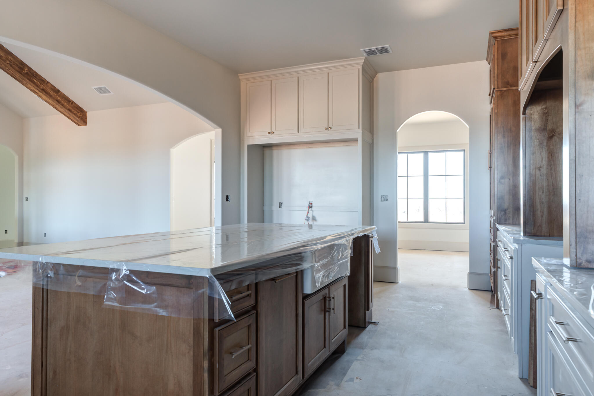 6309 Foster Road Ropesville, TX 79358 - Photo 8 of 38 a room with kitchen island a sink a counter and a window