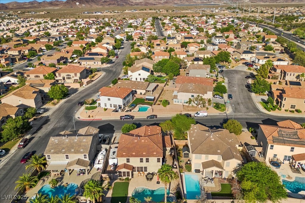 249 Cinnamon Ridge Way Henderson, NV 89015 - Photo 72 of 76 Aerial overview of property's location with nearby suburban area and a mountain backdrop