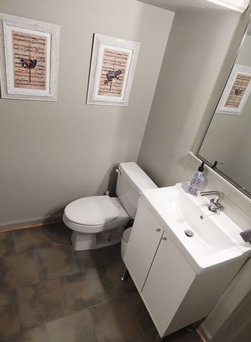a white toilet sitting next to a bathroom sink