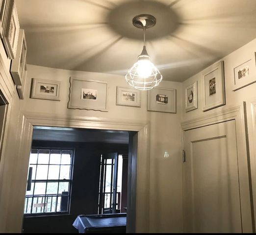 a view of kitchen and hall with wooden floor