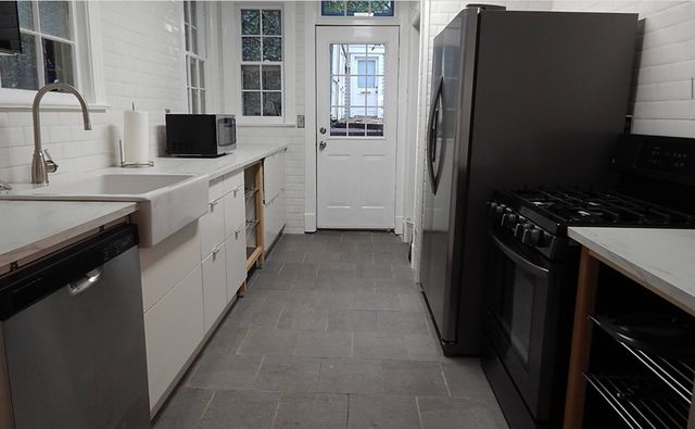 a kitchen with stainless steel appliances a refrigerator sink and stove