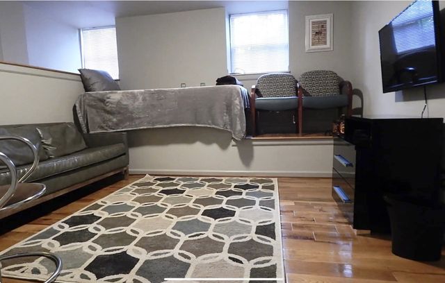 a living room with a couch and a flat screen tv