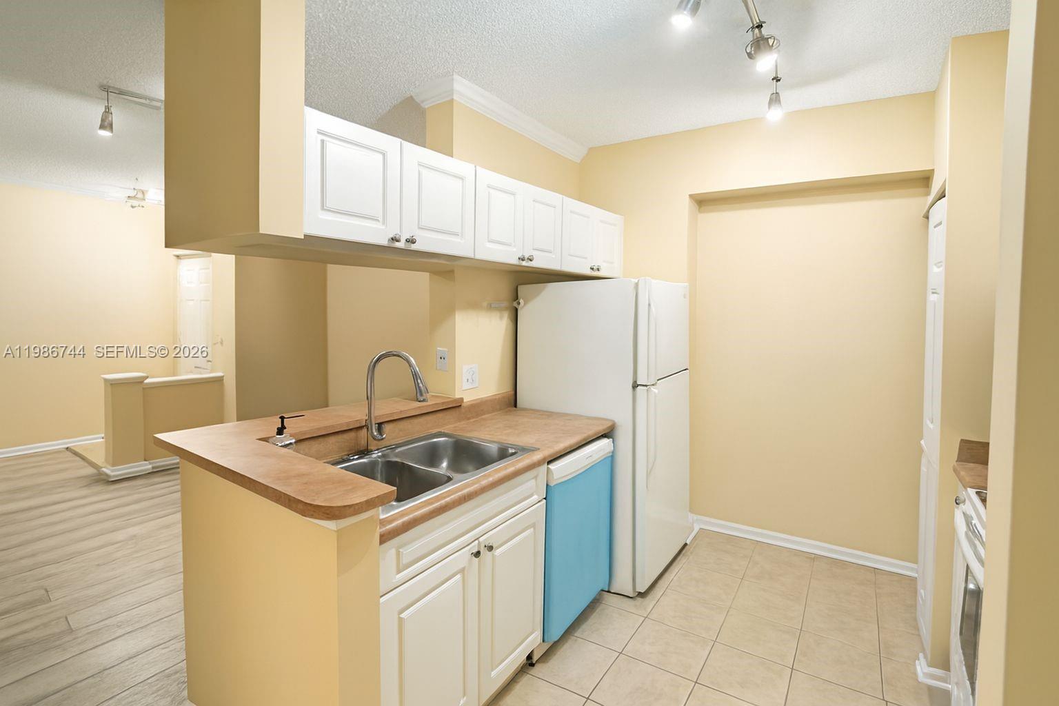 17150 North Bay Road, Unit 2122 Sunny Isles Beach, FL 33160 - Photo 6 of 19 a kitchen with stainless steel appliances granite countertop a sink stove and refrigerator