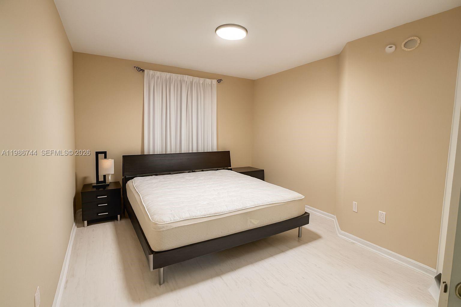 17150 North Bay Road, Unit 2122 Sunny Isles Beach, FL 33160 - Photo 8 of 19 a bedroom with a bed and window