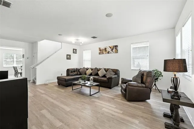a spacious bathroom with a double vanity sink a large mirror and a bathtub