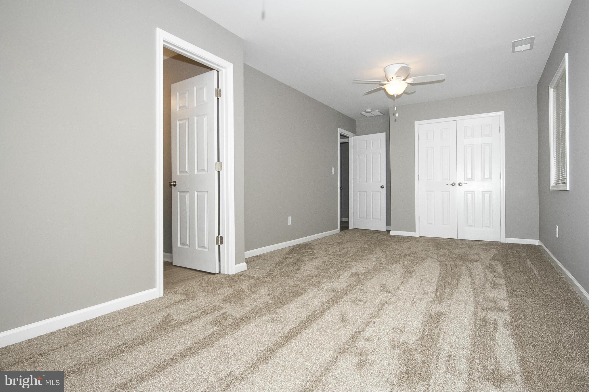700 Middle River Road Baltimore, MD 21220 - Photo 14 of 29 a view of an empty room with chandelier fan and wooden floor