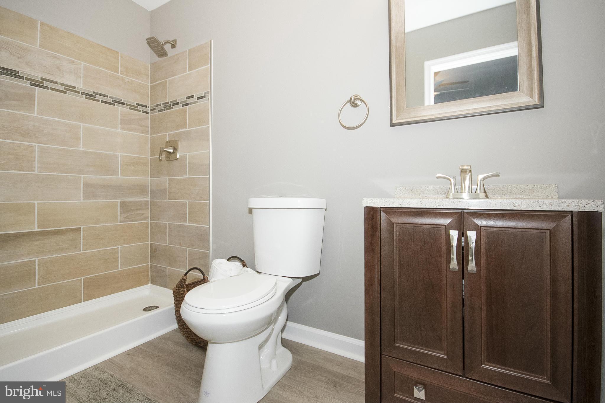 700 Middle River Road Baltimore, MD 21220 - Photo 15 of 29 a bathroom with a sink a toilet and shower
