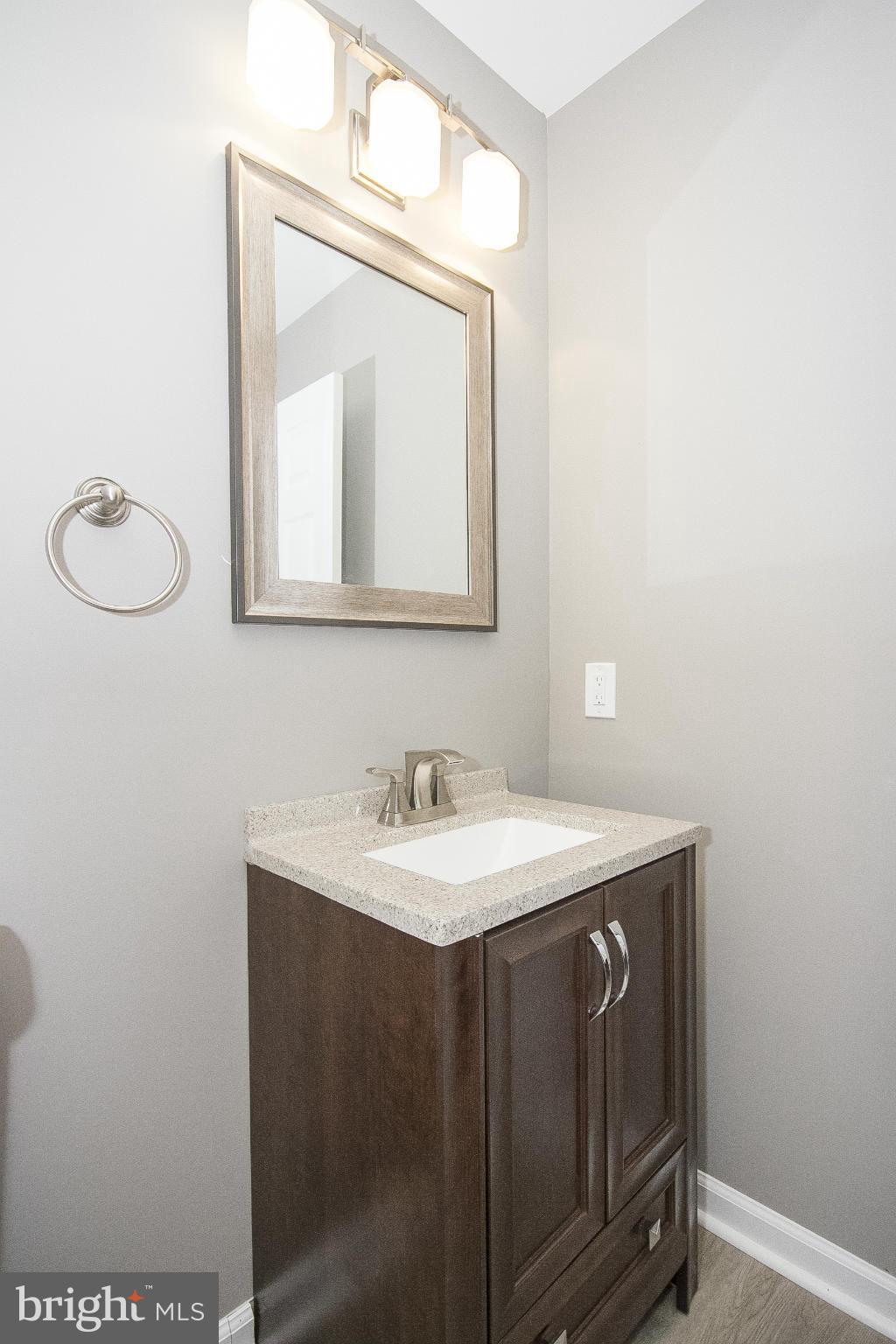 700 Middle River Road Baltimore, MD 21220 - Photo 16 of 29 a bathroom with a toilet sink vanity and mirror