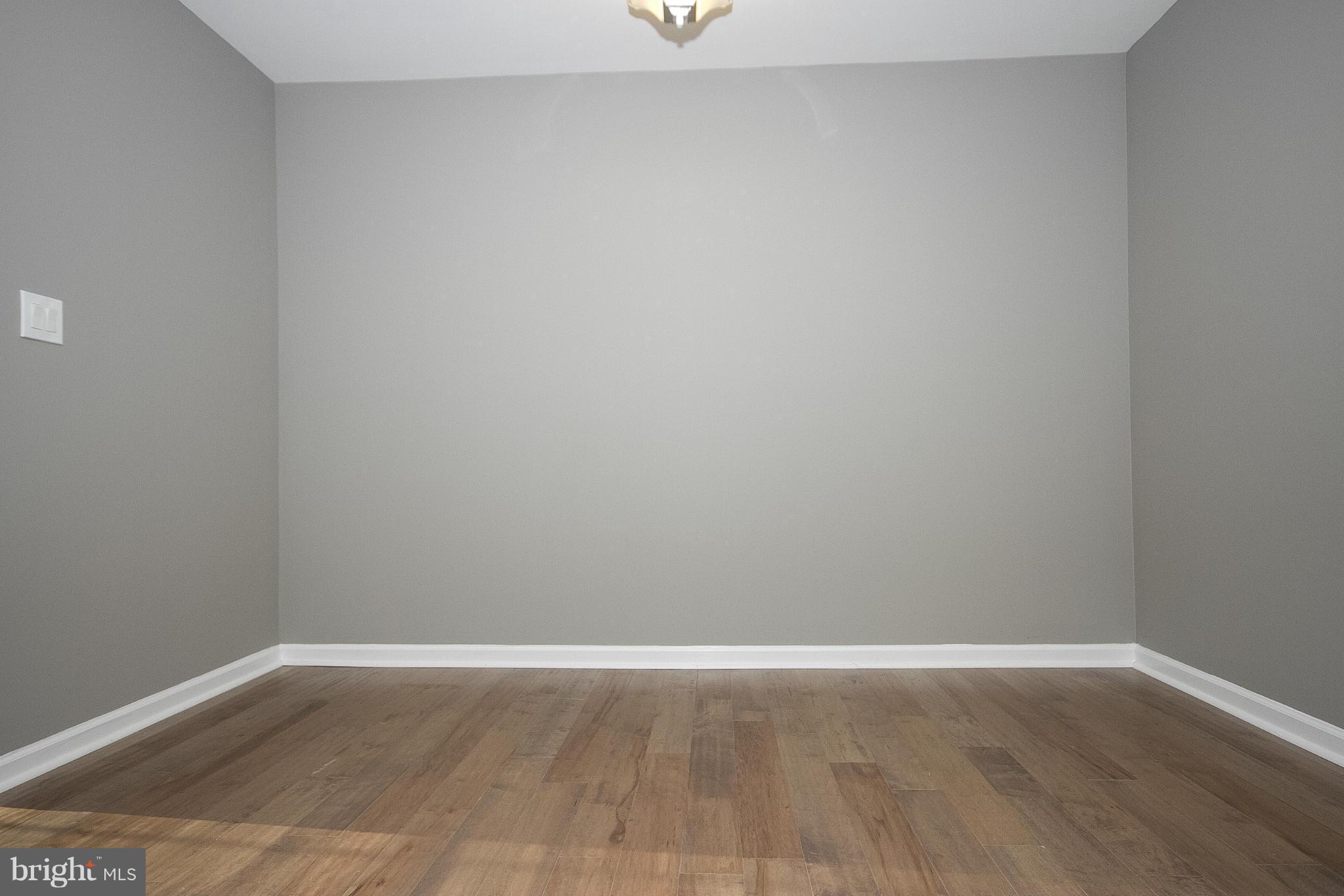 700 Middle River Road Baltimore, MD 21220 - Photo 19 of 29 a view of an empty room with wooden floor and a window
