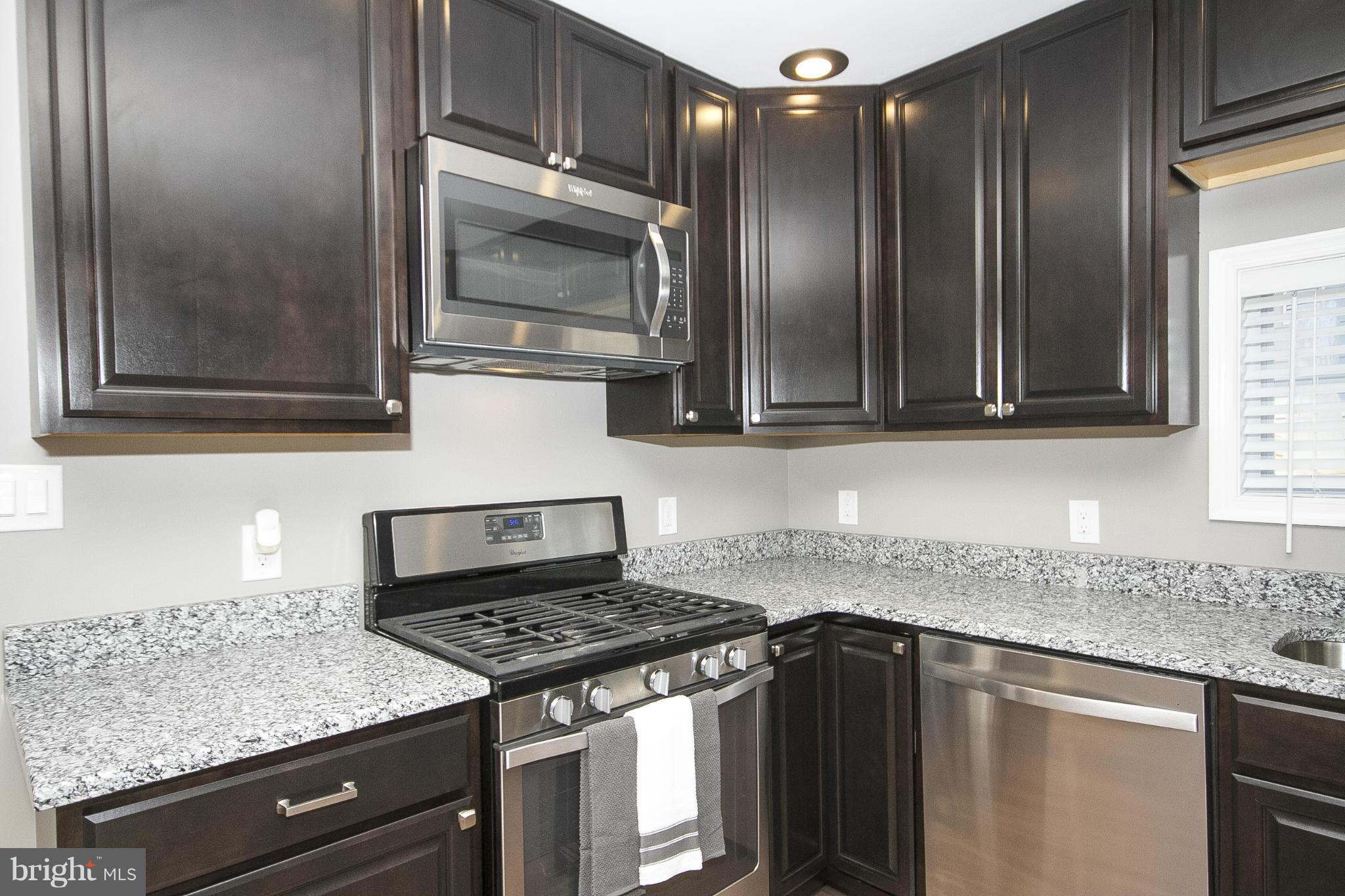 700 Middle River Road Baltimore, MD 21220 - Photo 4 of 29 a kitchen with granite countertop stainless steel appliances and cabinets
