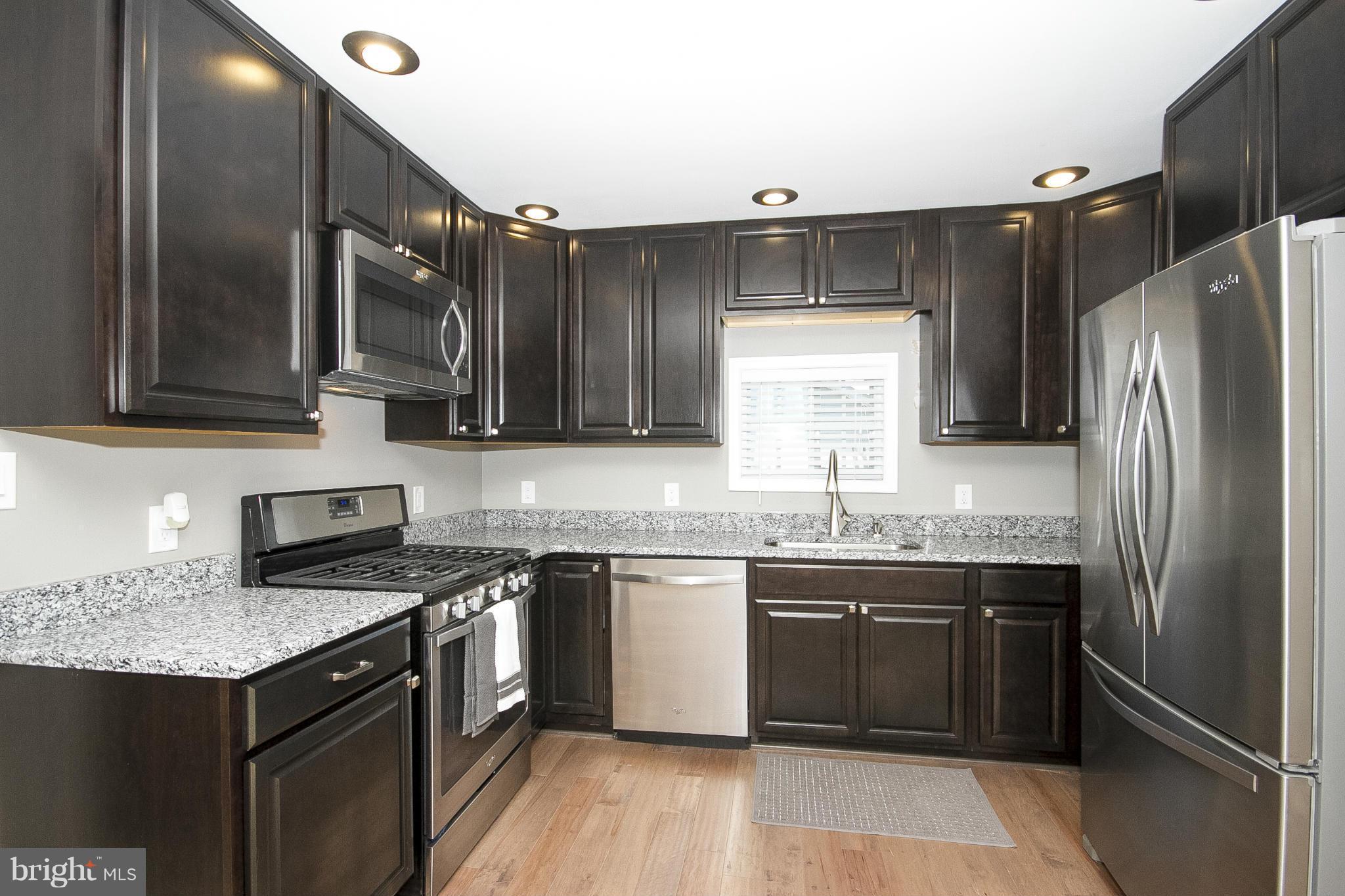 700 Middle River Road Baltimore, MD 21220 - Photo 5 of 29 a kitchen with stainless steel appliances granite countertop a sink stove and refrigerator