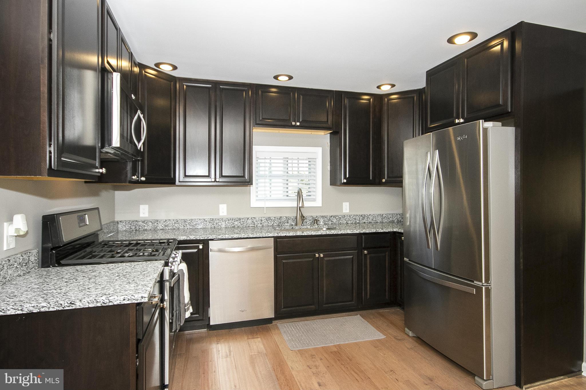 700 Middle River Road Baltimore, MD 21220 - Photo 6 of 29 a kitchen with granite countertop a sink stainless steel appliances and cabinets