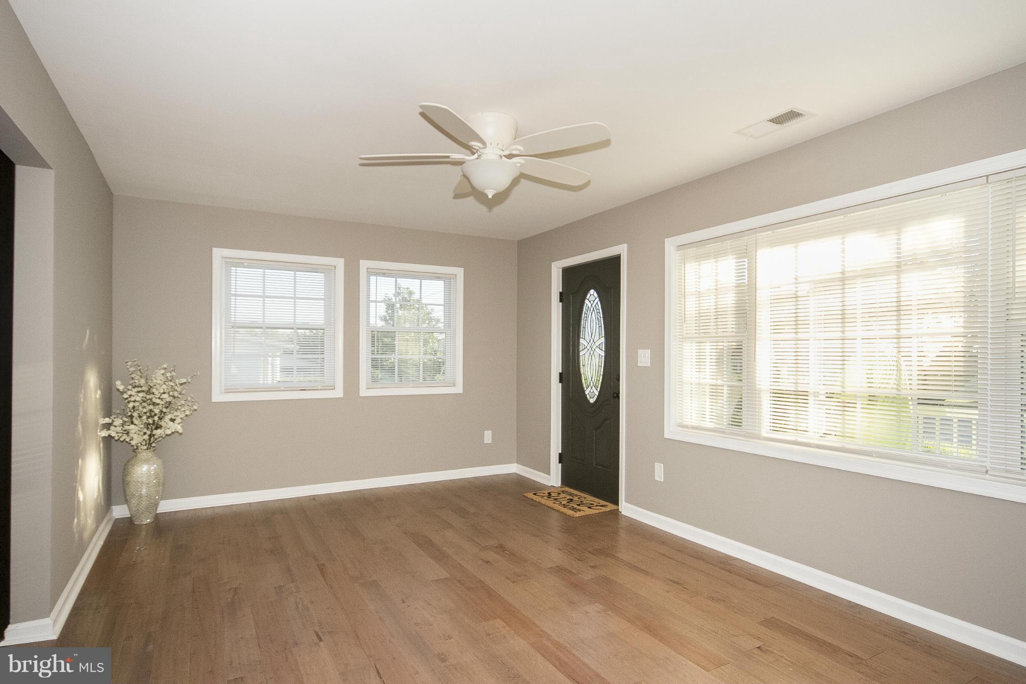 700 Middle River Road Baltimore, MD 21220 - Photo 8 of 29 a view of an empty room with a window and wooden floor