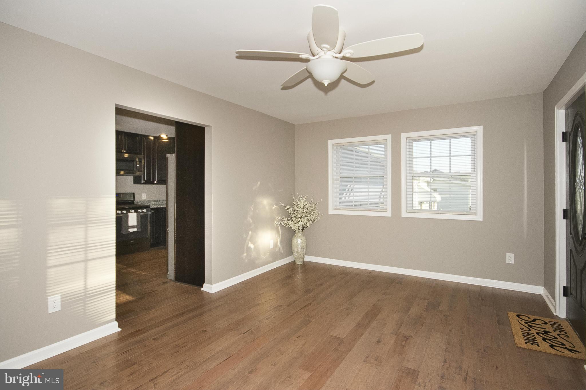 700 Middle River Road Baltimore, MD 21220 - Photo 9 of 29 a view of livingroom with hardwood floor and ceiling fan