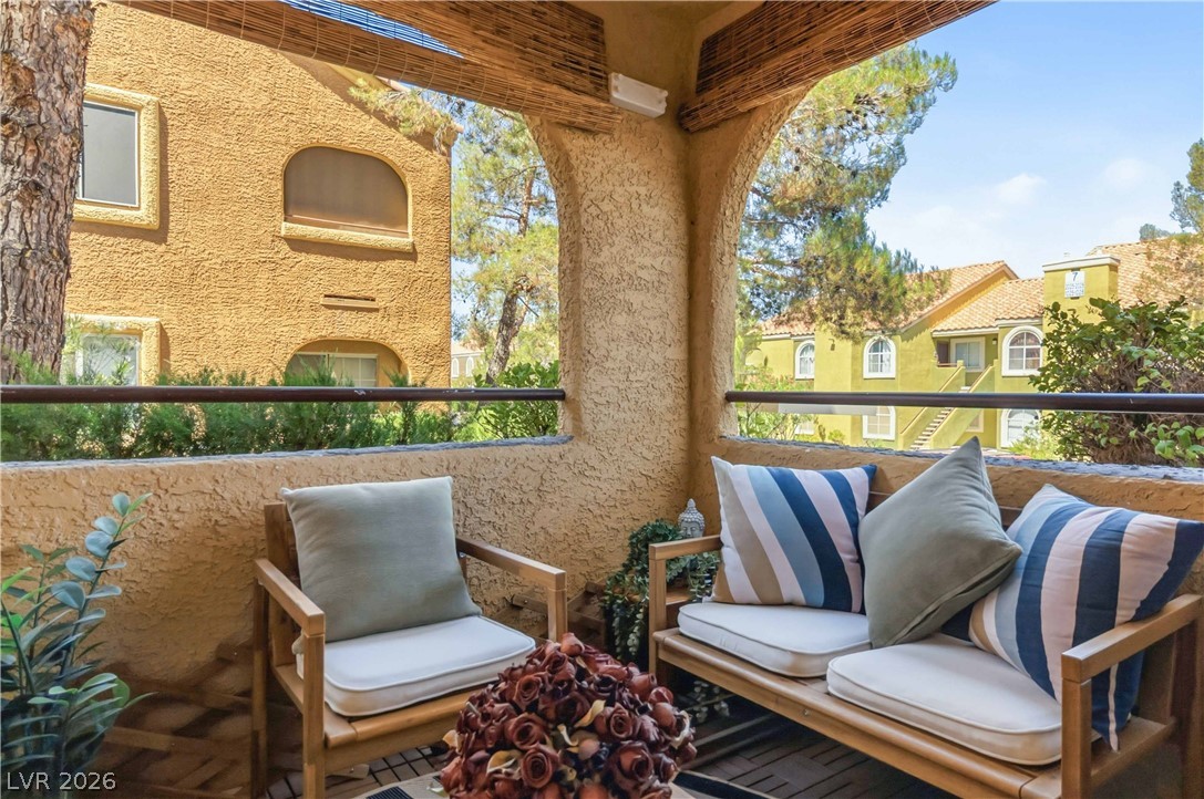 7950 West Flamingo Road, Unit 1180 Las Vegas, NV 89147 - Photo 24 of 26 An inviting outdoor patio offers comfortable seating and views of the community beyond.