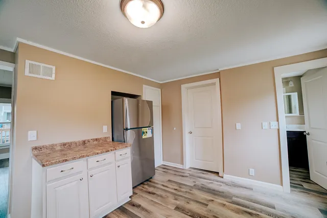 a spacious bathroom with a granite countertop sink and a mirror