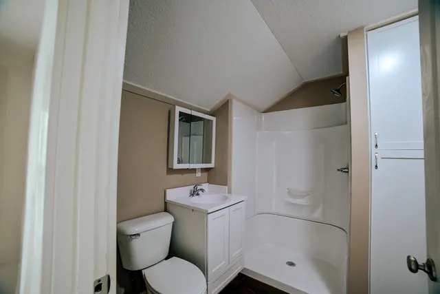 a bathroom with a toilet sink and shower